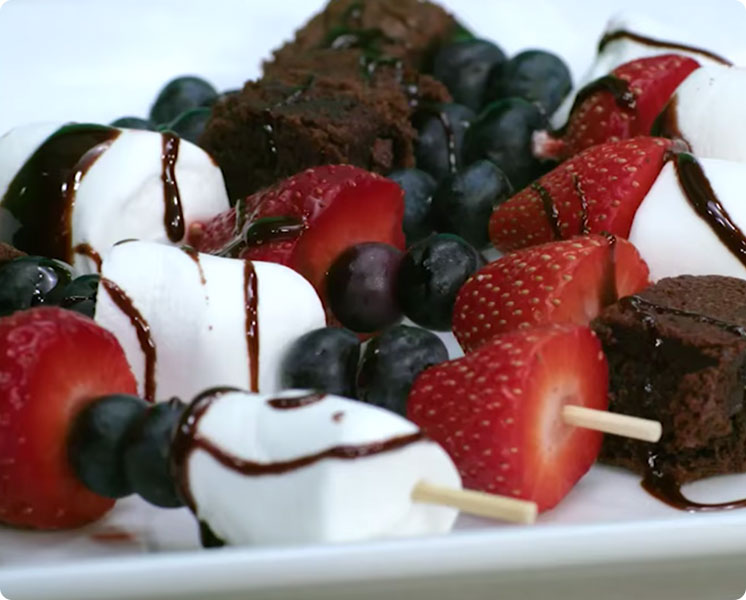 Image of blueberry kabobs with marsh-mellows, brownies and strawberries